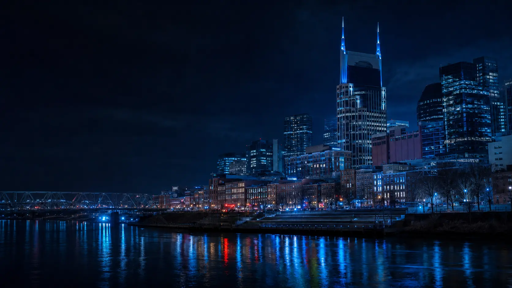 Nashville skyline at night reflected across the Cumberland River